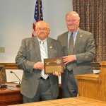 Retiring Clerk of Court Steve Hales accepts a key to the city from Mayor Rick Meehan.